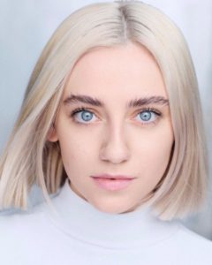 Headshot of actress with blond hair and blue eyes in front of a white background taken by Kim Hardy headshot photographer in his London studio