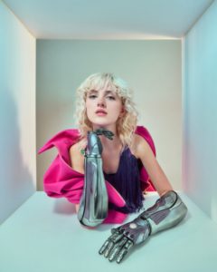 Tilly photographed by Kim Hardy in His London studio featuring bionic arms, pink top and a light box