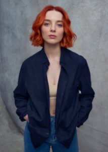 Acting headshot of red hair woman wearing a dark blue top taken by Kim Hardy Photography in his London studio in front of a grey backdrop