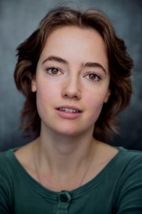 close up headshot of actor Yzzy Forsdyke wearing a green top taken by Kim Hardy in his London photography studio in front of a dark backdrop