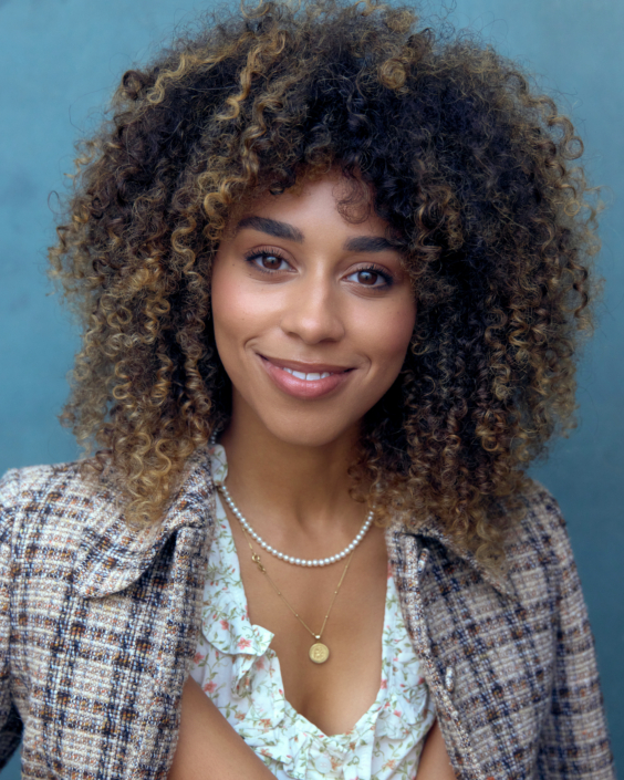 middle sized headshot of actor Annabella King wearing a checked top taken by Kim Hardy in his London studio in front of a blue background