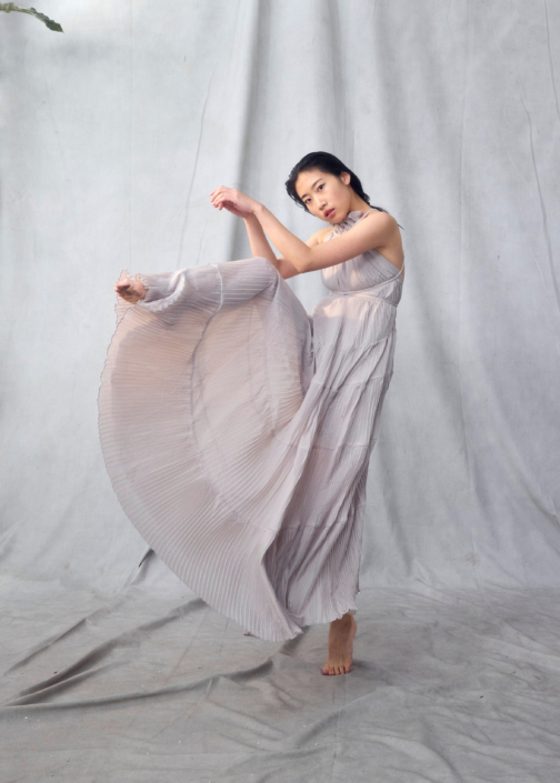 dancer headshot of young actress in a floaty dress in front of a grey background taken by Kim Hardy in his London studio